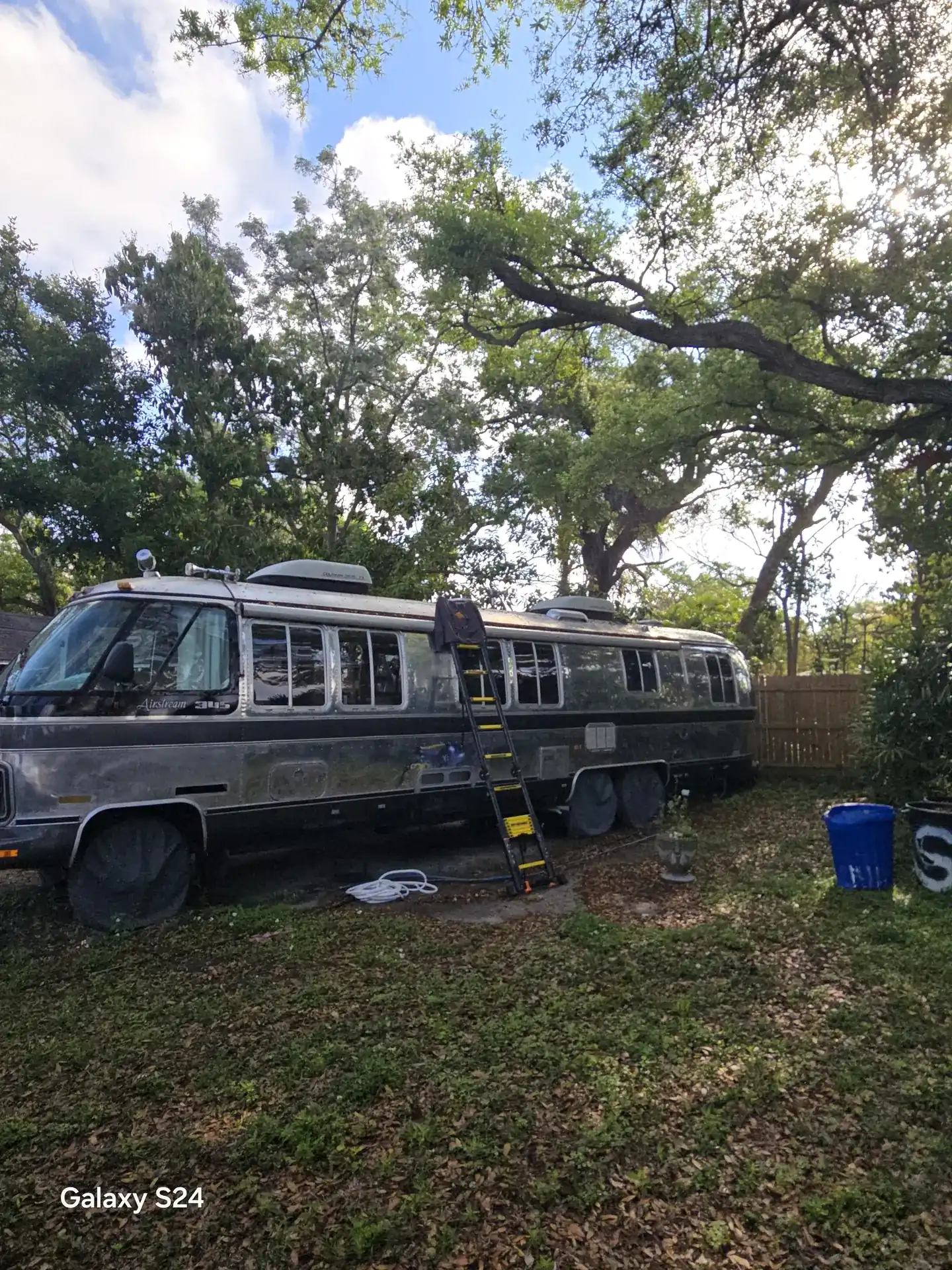 Ladder set against a vintage Airstream motorhome during a mobile roof repair in Bradenton, FL